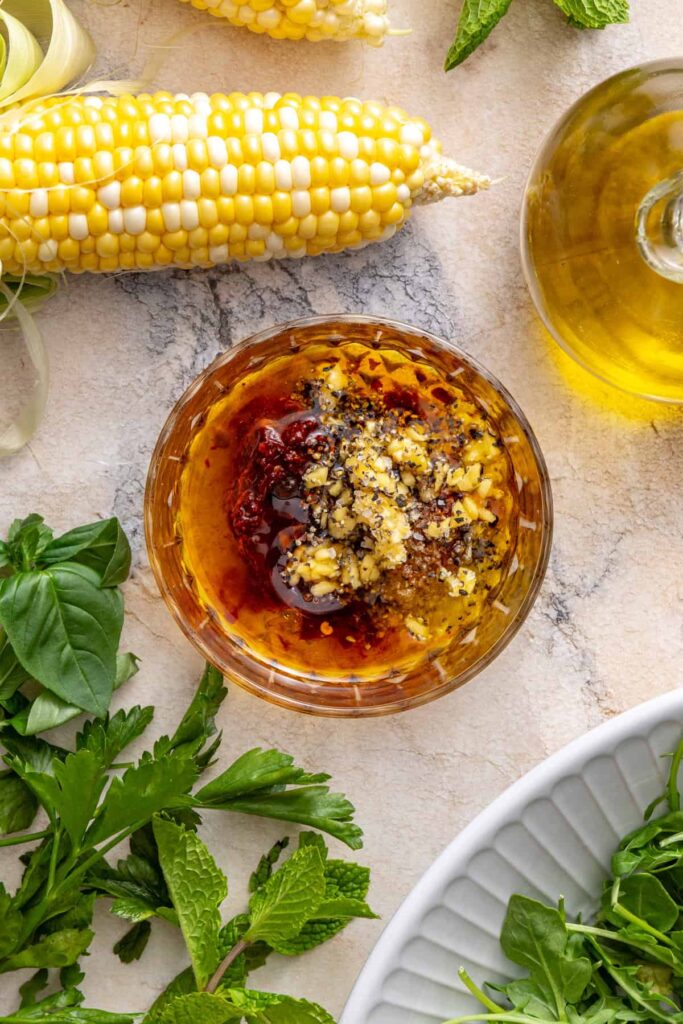 overhead view of ingredients for hot honey harissa marinade for steak in a bowl