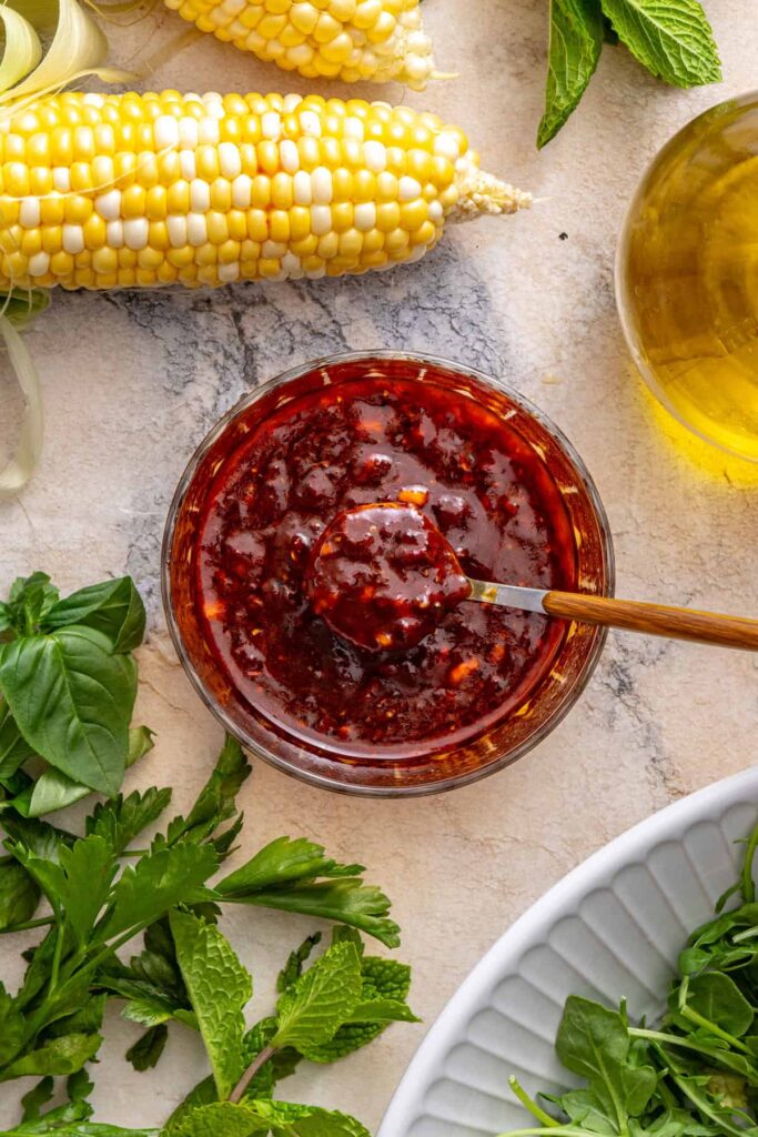 Homemade harissa marinade being mixed in a small bowl for grilled flank steak