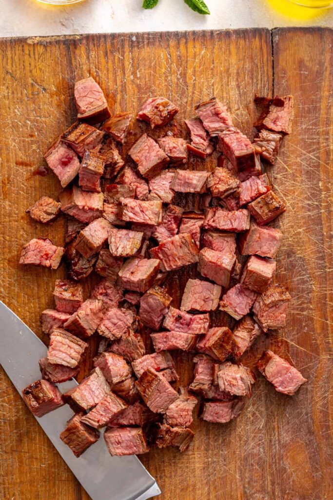 Thinly sliced harissa steak ready to add to a summer salad