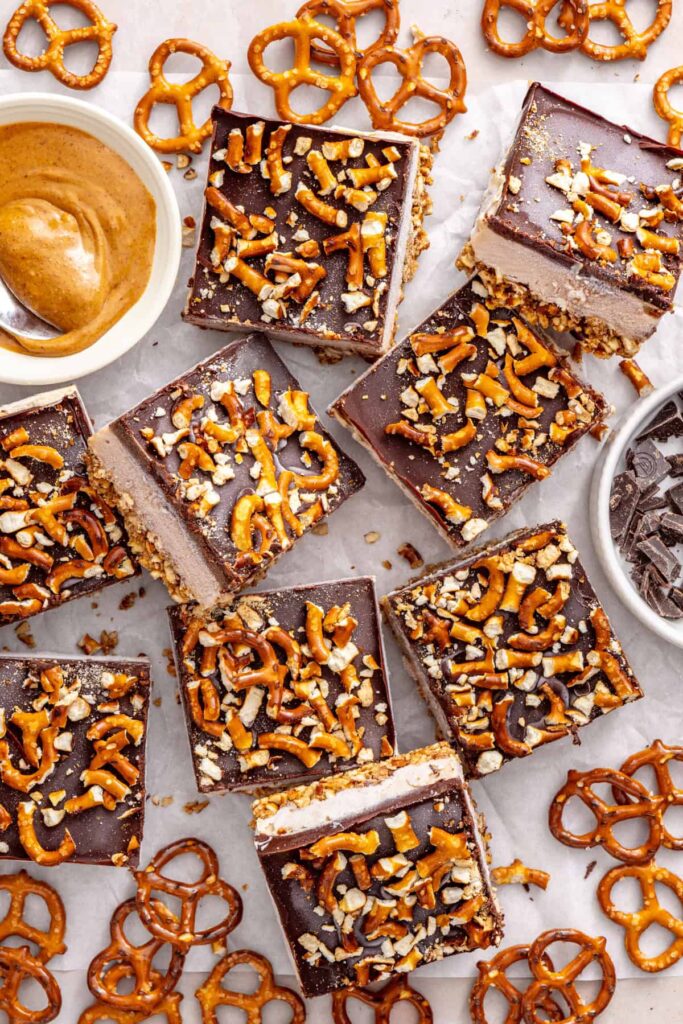 Overhead view of sliced frozen peanut butter pretzel bars on a serving table.