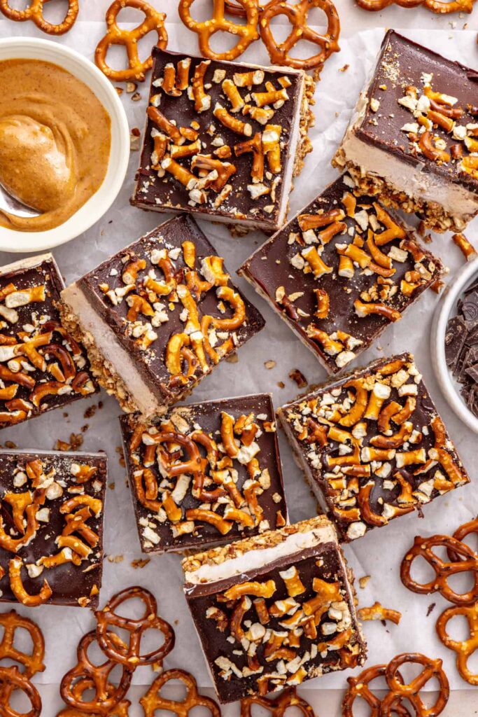 High-protein frozen peanut butter bars served with gluten-free pretzels.