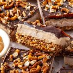 Close-up of Frozen Peanut Butter Pretzel Bars showing the creamy peanut butter protein filling, crunchy pretzel crust, and dark chocolate topping.