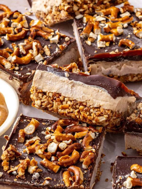 Close-up of Frozen Peanut Butter Pretzel Bars showing the creamy peanut butter protein filling, crunchy pretzel crust, and dark chocolate topping.