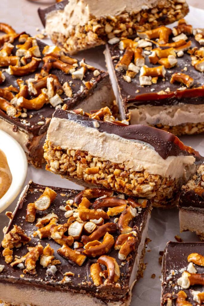 Close-up of Frozen Peanut Butter Pretzel Bars showing the creamy peanut butter protein filling, crunchy pretzel crust, and dark chocolate topping.
