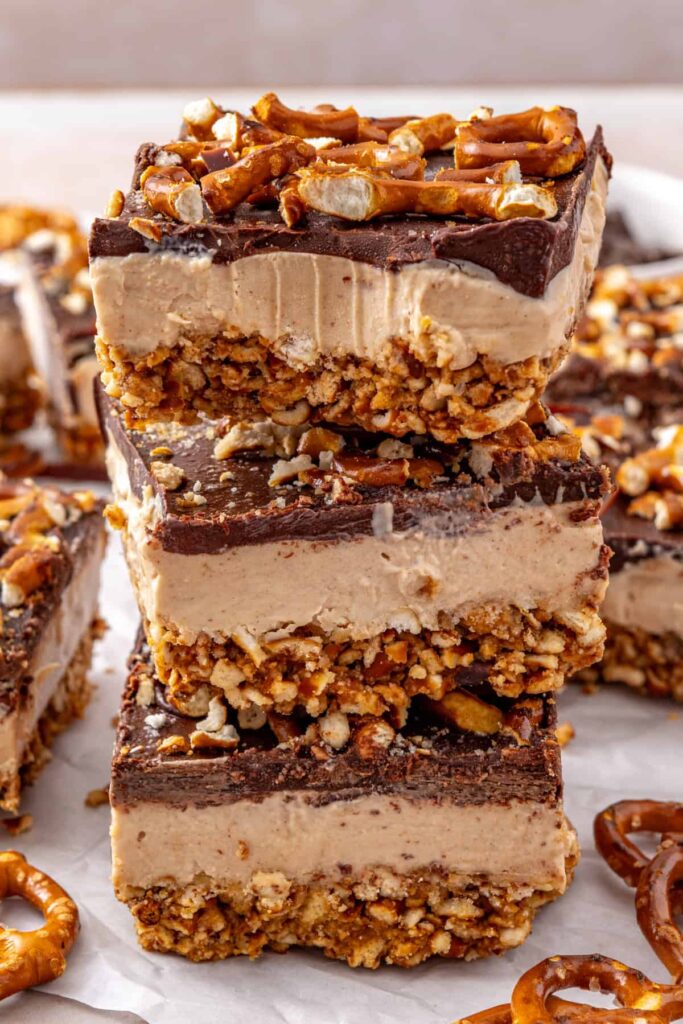 Stacked frozen peanut butter pretzel bars showing the creamy peanut butter filling.