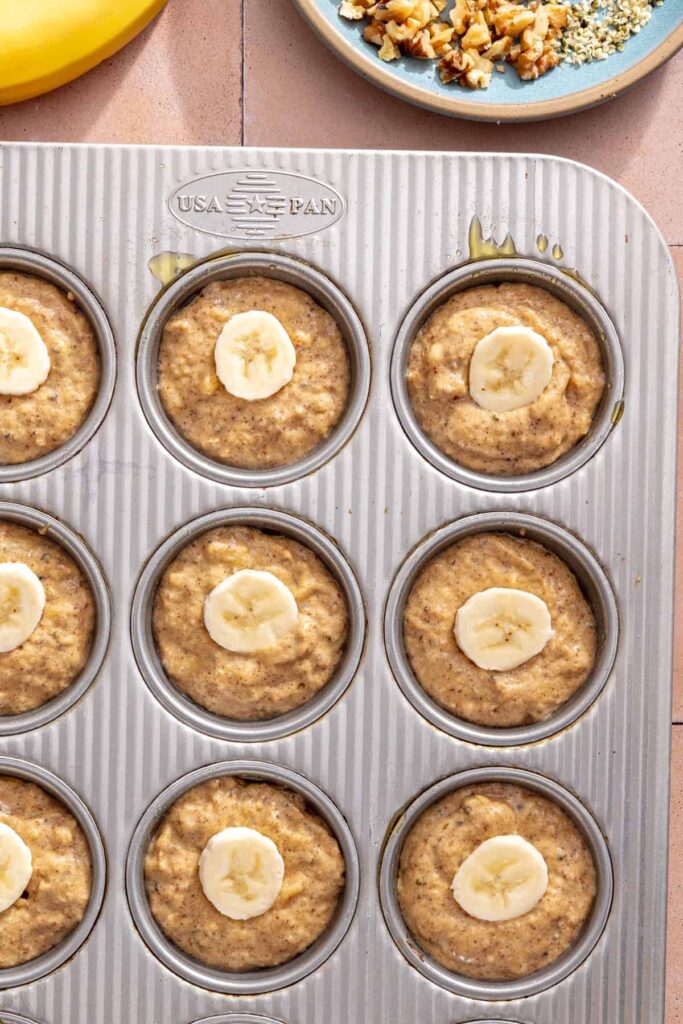 Banana slices pressed onto muffin batter before baking