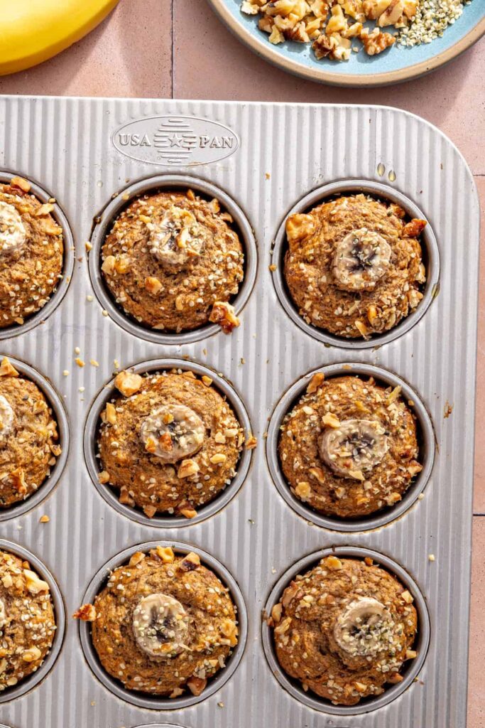 Freshly baked toddler banana muffins cooling in the muffin pan