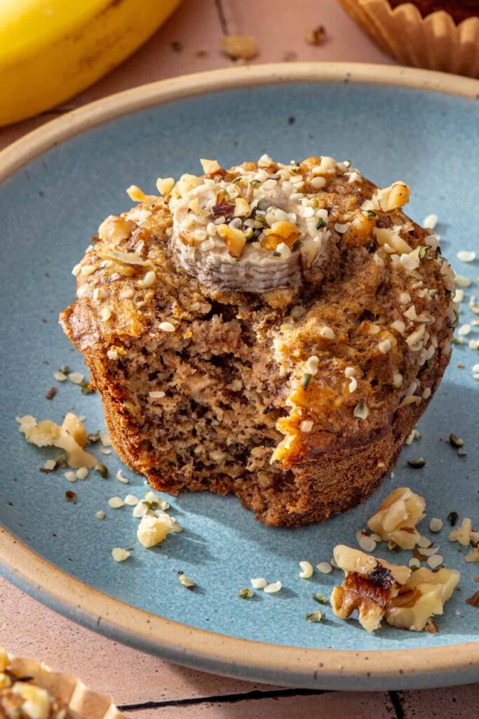 Gluten-free toddler banana muffin with a bite taken out showing the soft fluffy interior