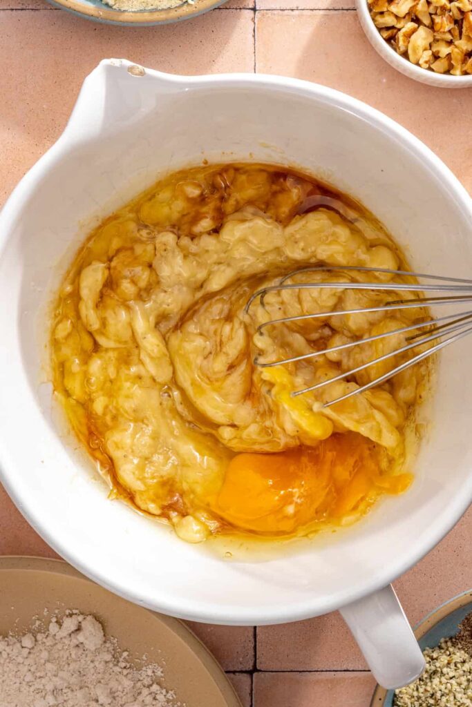 Combining wet ingredients for gluten-free toddler banana muffins