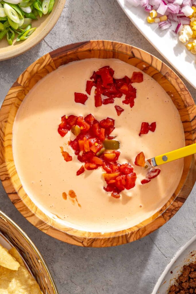 Diced Rotel tomatoes stirred into cottage cheese queso