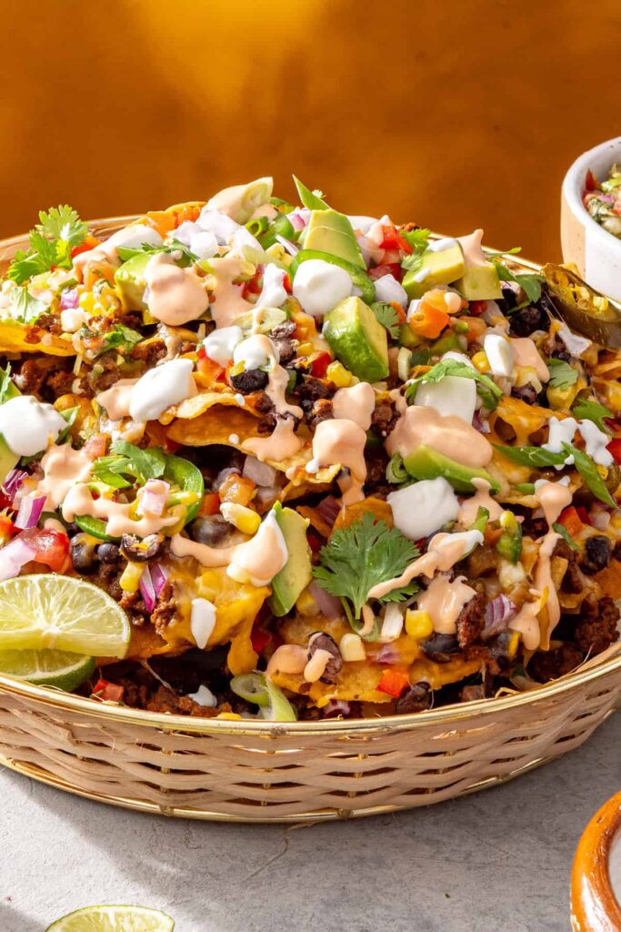 Basket of loaded air fryer beef nachos with cottage cheese queso on top
