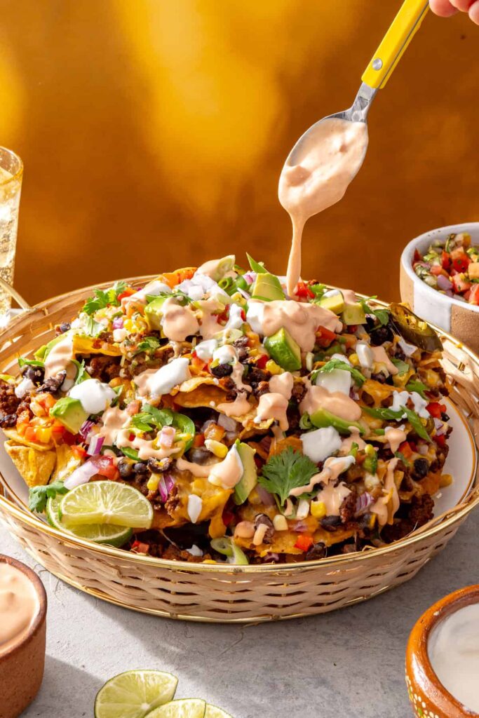 Cottage cheese queso drizzled over loaded air fryer beef nachos