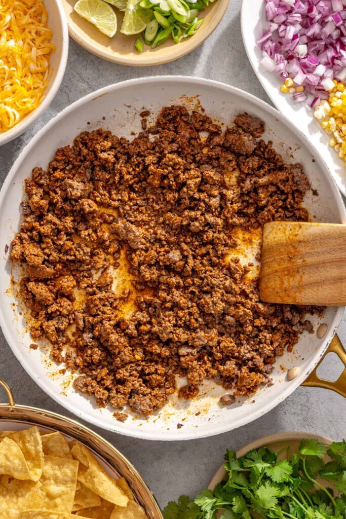 Taco seasoning and water added to cooked ground beef for air fryer nachos
