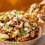 Air fryer beef nachos with cottage cheese queso in a serving basket