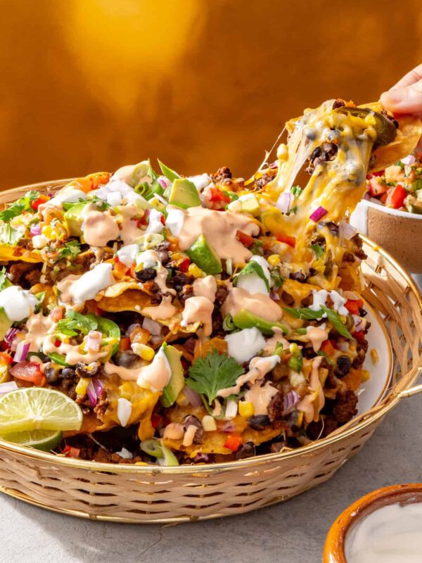 Air fryer beef nachos with cottage cheese queso in a serving basket