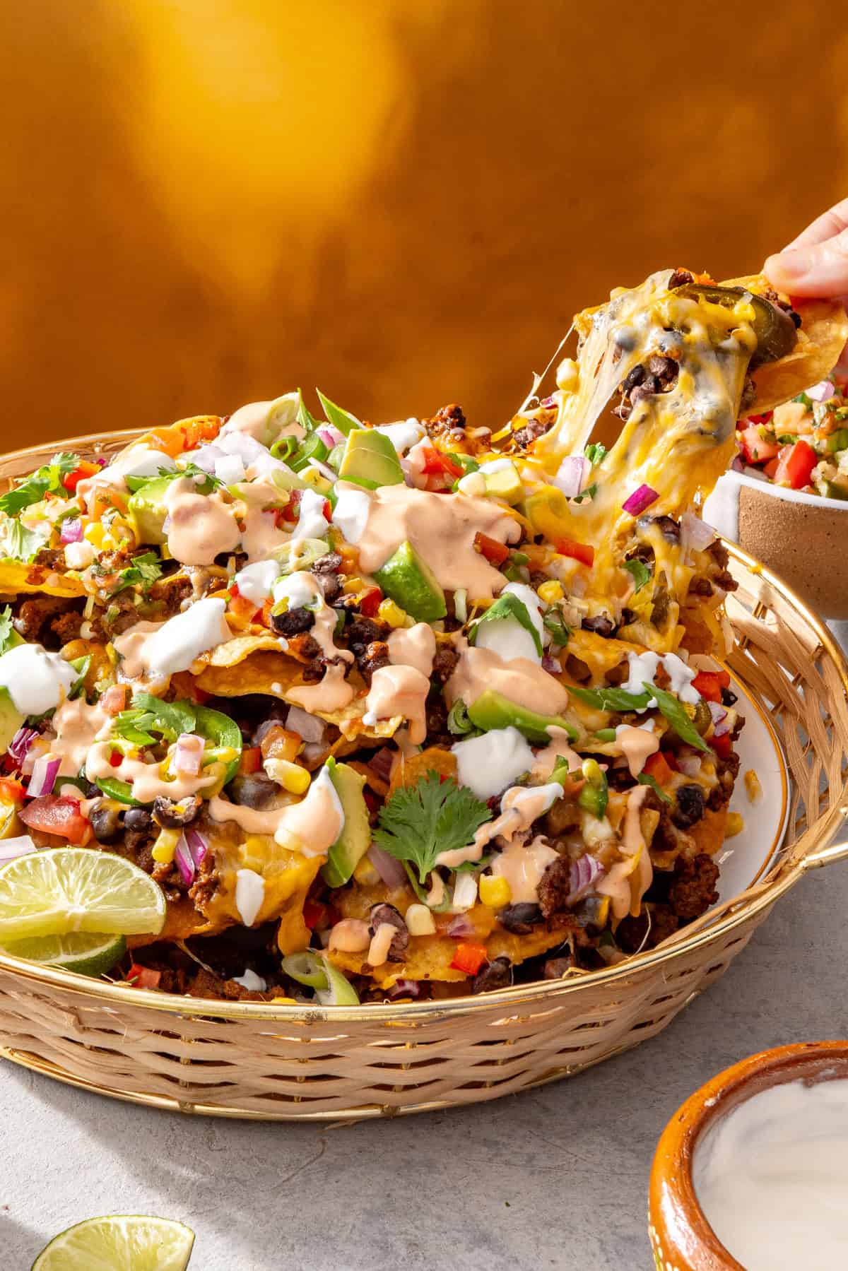 Air fryer beef nachos with cottage cheese queso in a serving basket