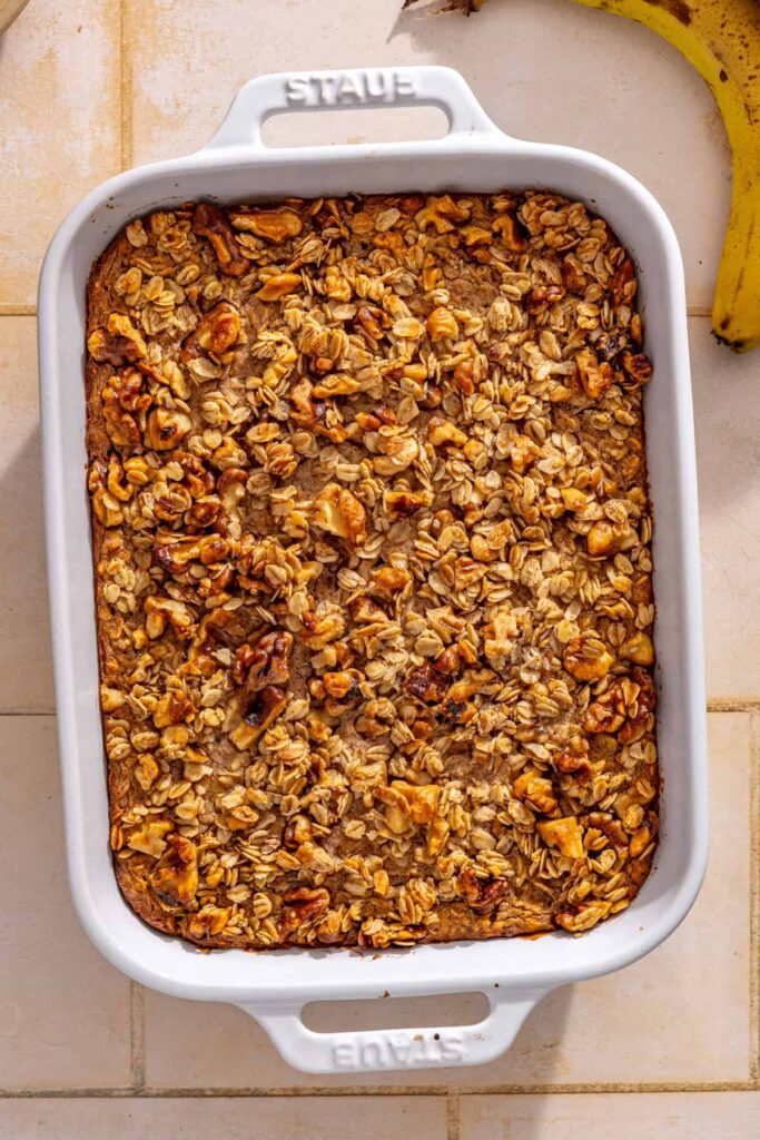 Freshly baked banana bread baked oatmeal with a golden maple walnut crumble topping