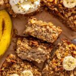 Banana bread baked oatmeal slices with maple walnut crumble and banana, showing the baked oatmeal texture