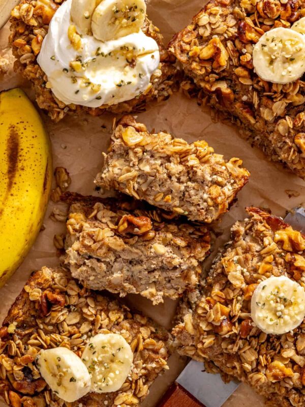 Banana bread baked oatmeal slices with maple walnut crumble and banana, showing the baked oatmeal texture