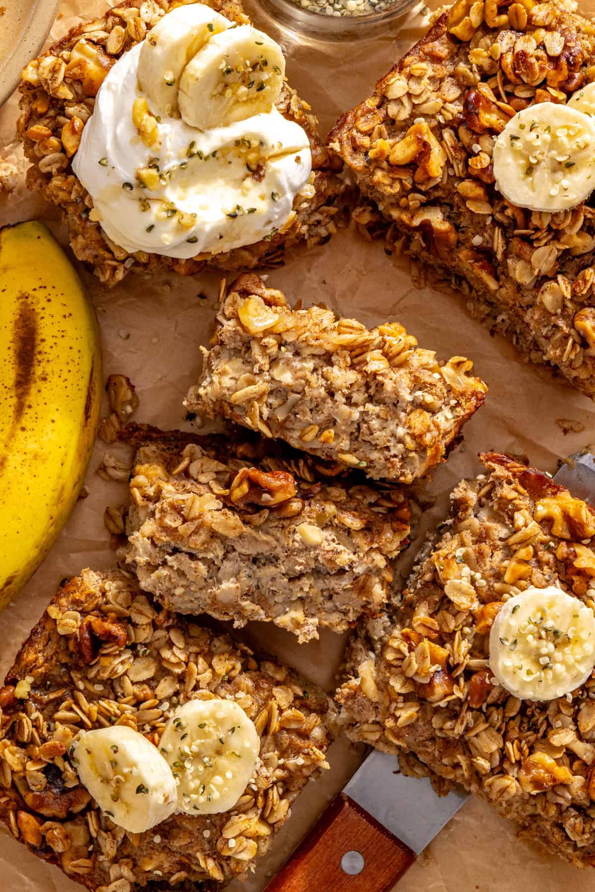 Banana bread baked oatmeal slices with maple walnut crumble and banana, showing the baked oatmeal texture