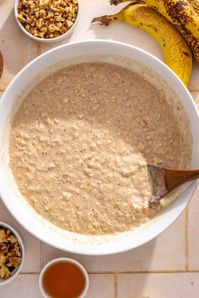 Combining wet and dry ingredients to make banana bread baked oatmeal