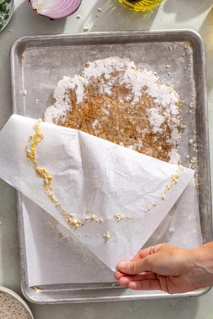 Flipping the giant breaded chicken cutlet onto a baking sheet