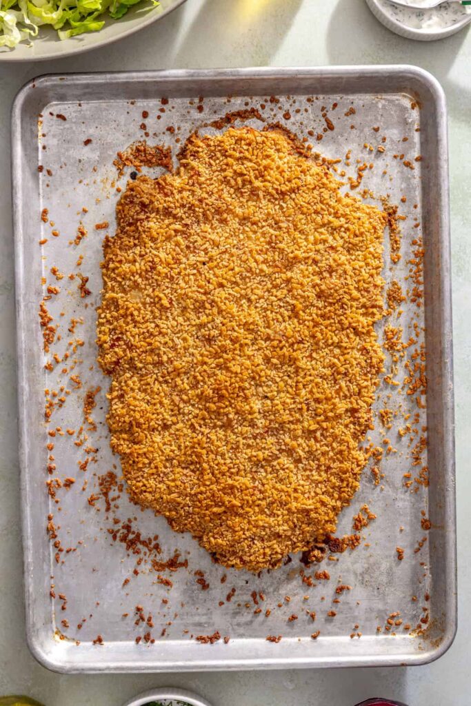 Golden crispy giant dill pickle chicken cutlet fresh from the oven