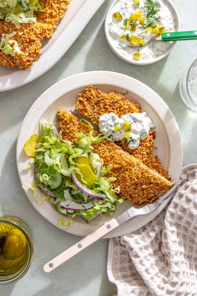 Single serving of crispy pickle chicken cutlet with creamy dill salad and pickle ranch