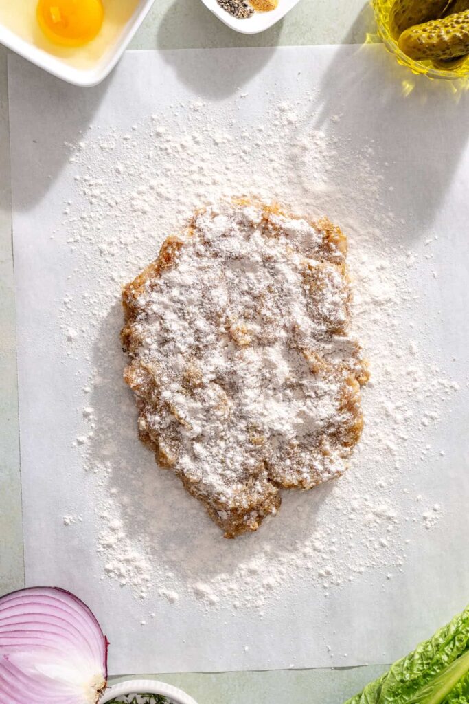 Ground chicken mixture prepared for pressing into a thin chicken cutlet