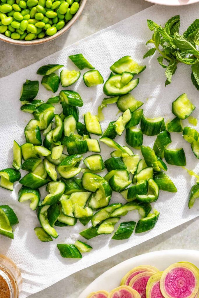 Squeezing salted cucumbers dry for a crisp cucumber salad