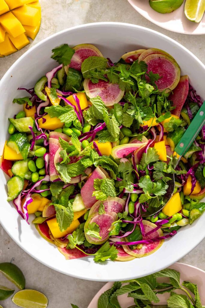 Diced mango folded into cucumber and edamame salad