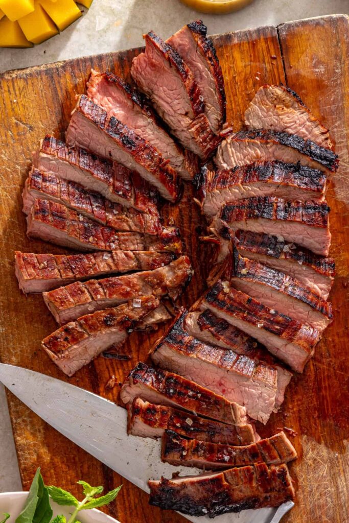 Grilled flank steak sliced against the grain for serving