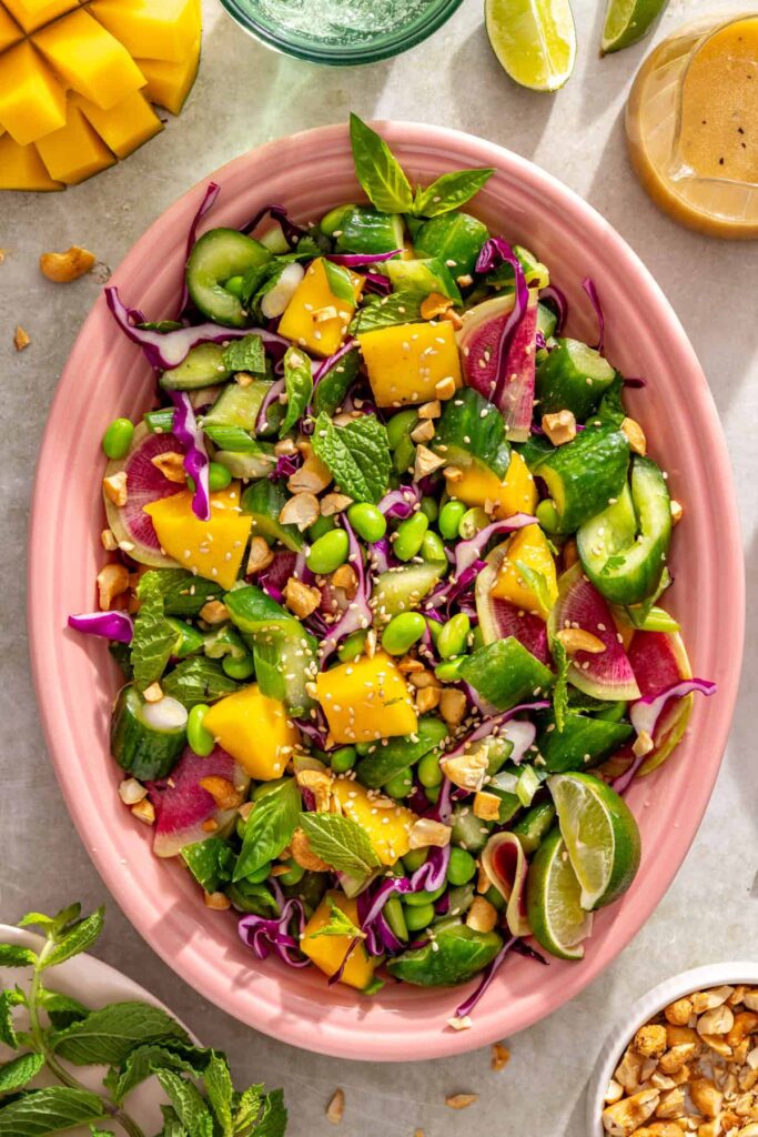 Smashed cucumber mango salad with edamame, cabbage, radishes and scallions