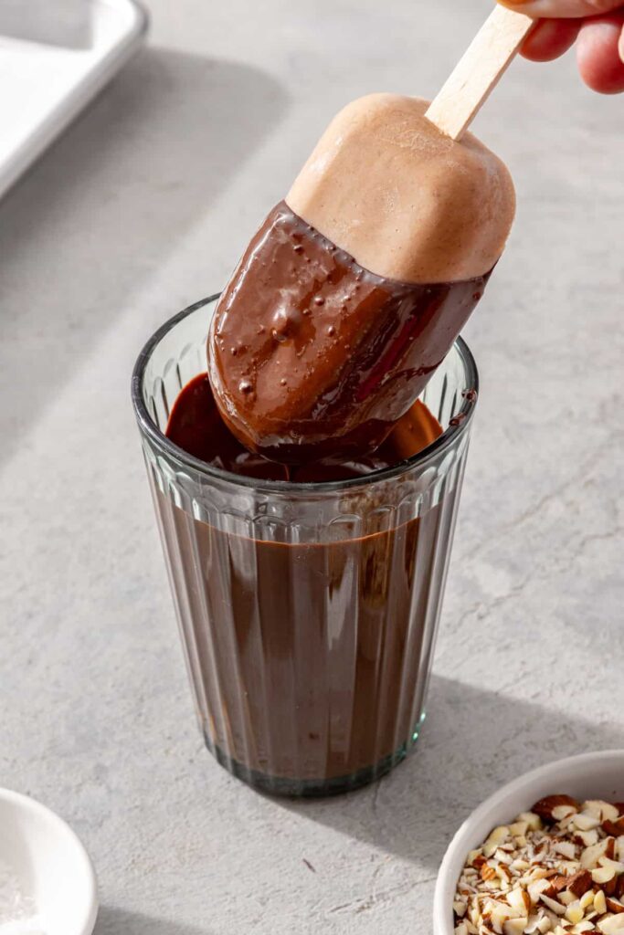 Banana ice cream bar dipped in melted chocolate to create a Magnum-style chocolate coating