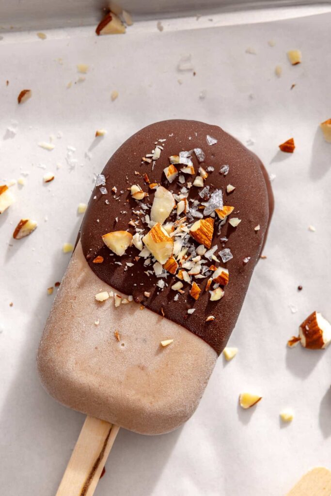 Chocolate-covered banana ice cream bars with chopped nuts and flaky salt