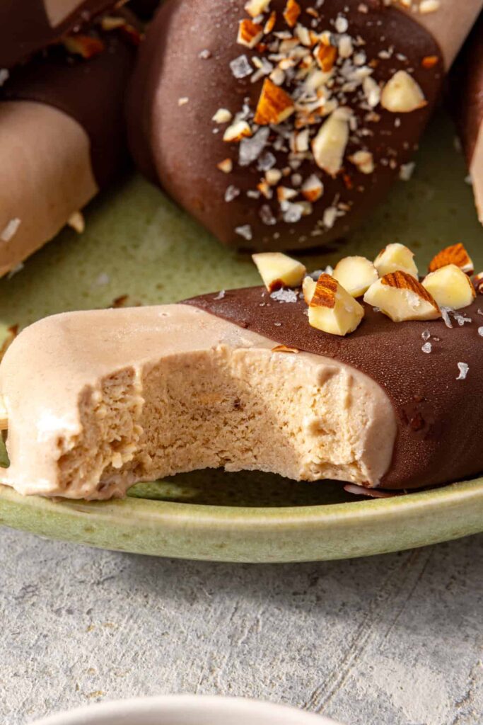 Close-up of a chocolate-coated homemade ice cream bar with a bite taken out