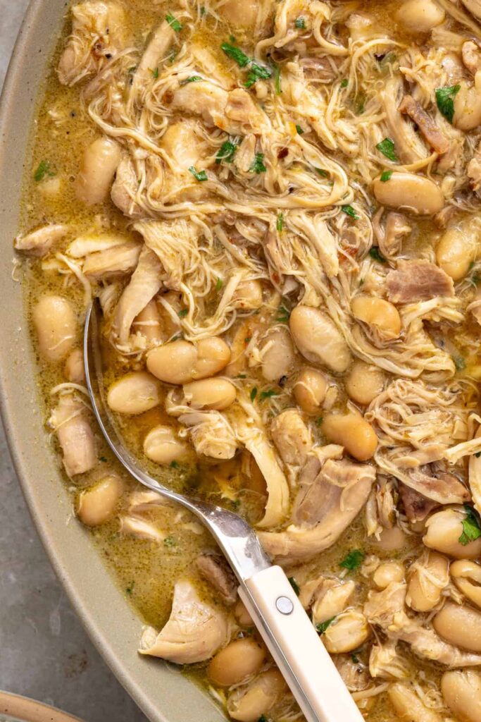 Close-up view of Instant Pot green enchilada chicken and beans served family-style