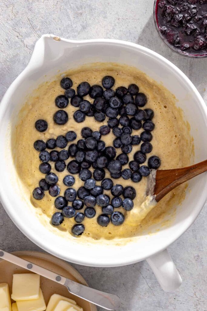 Fresh blueberries being folded into batter for lemon blueberry pancakes