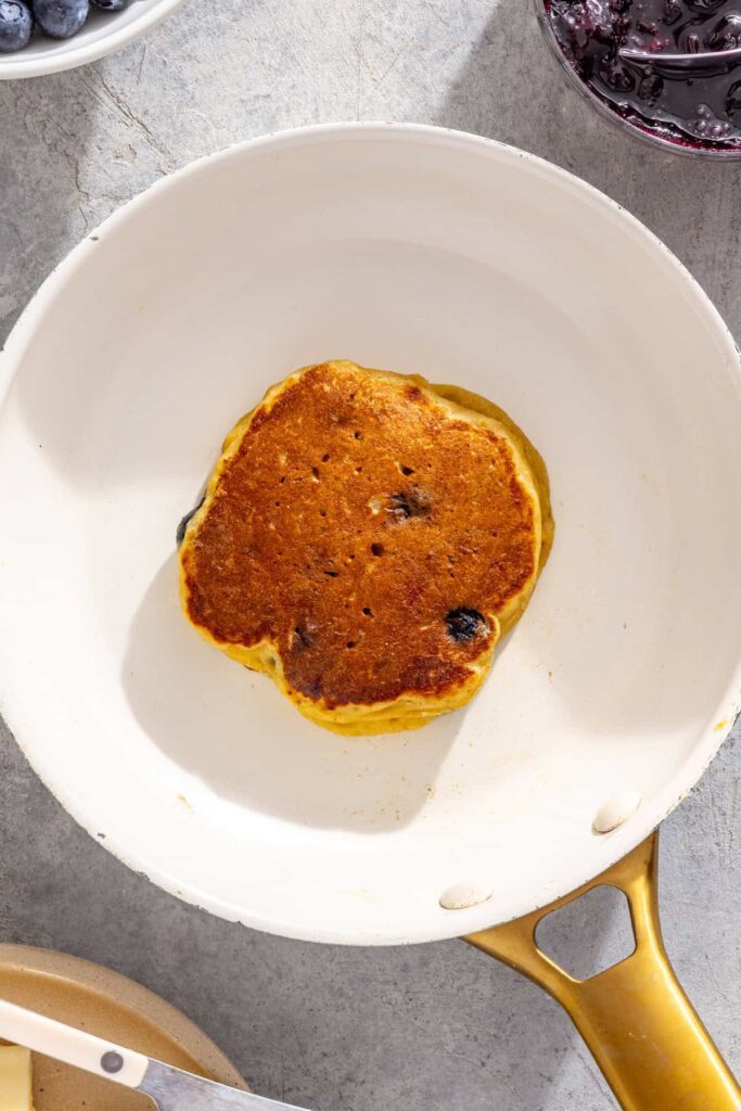 Freshly cooked lemon blueberry pancake in a skillet