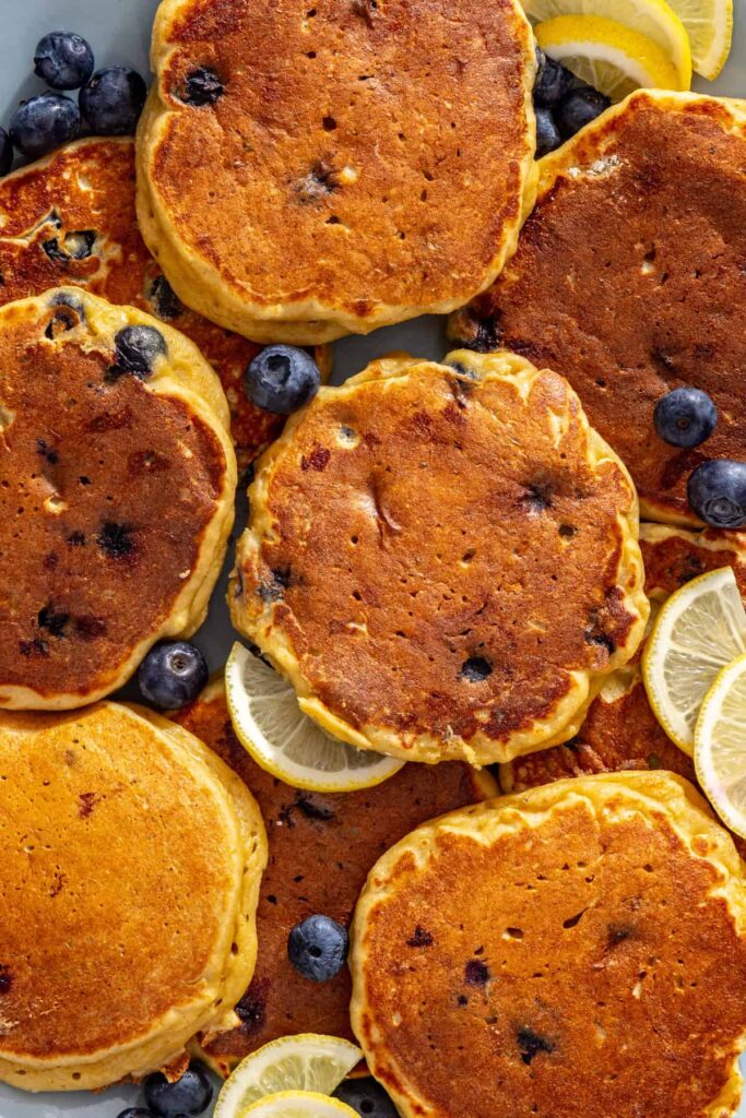 Close-up blueberry cottage cheese pancakes served with fresh blueberries and lemon slices