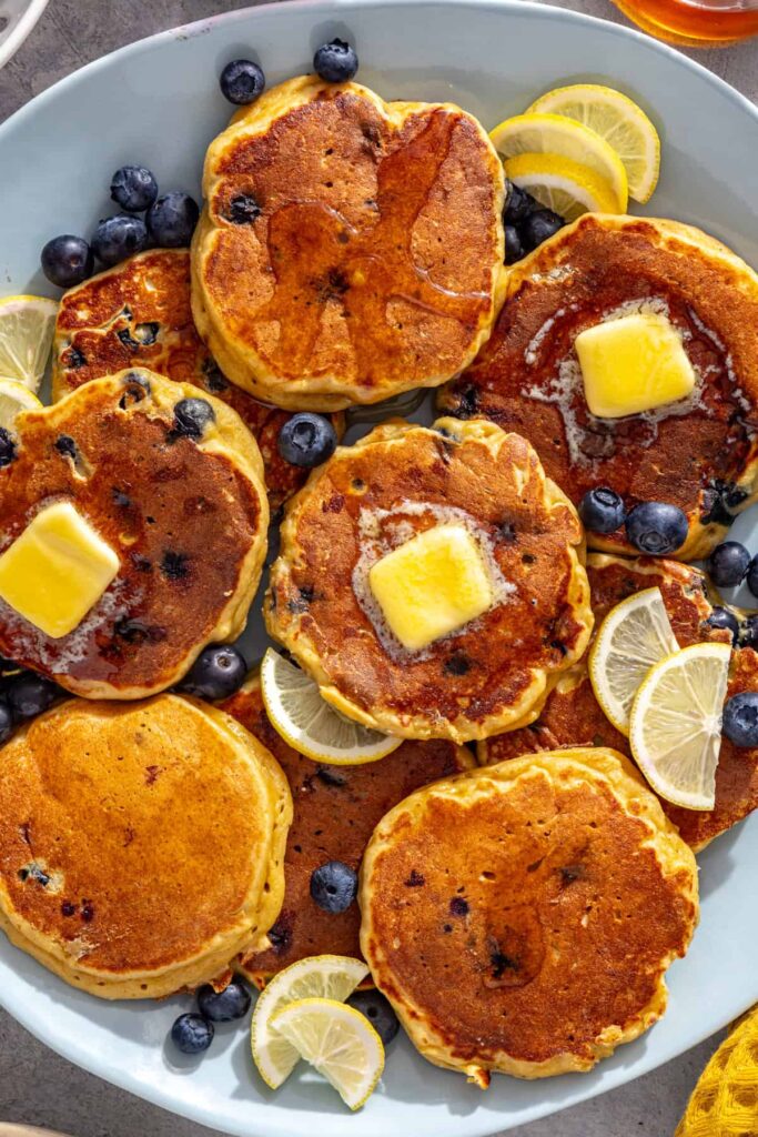 High-protein cottage cheese pancakes topped with melting butter and fresh blueberries