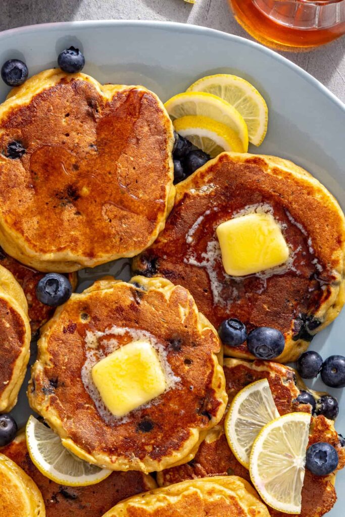 Close-up high-protein cottage cheese pancakes topped with butter and blueberries