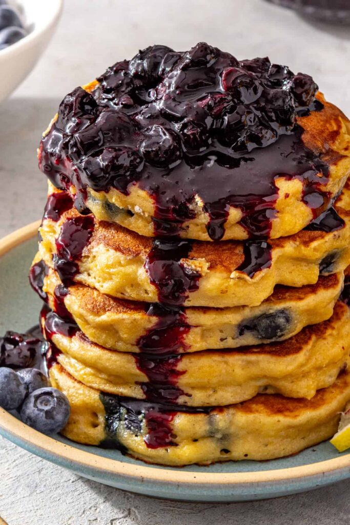 Blueberry cottage cheese pancake stack with spoonful of blueberry honey compote
