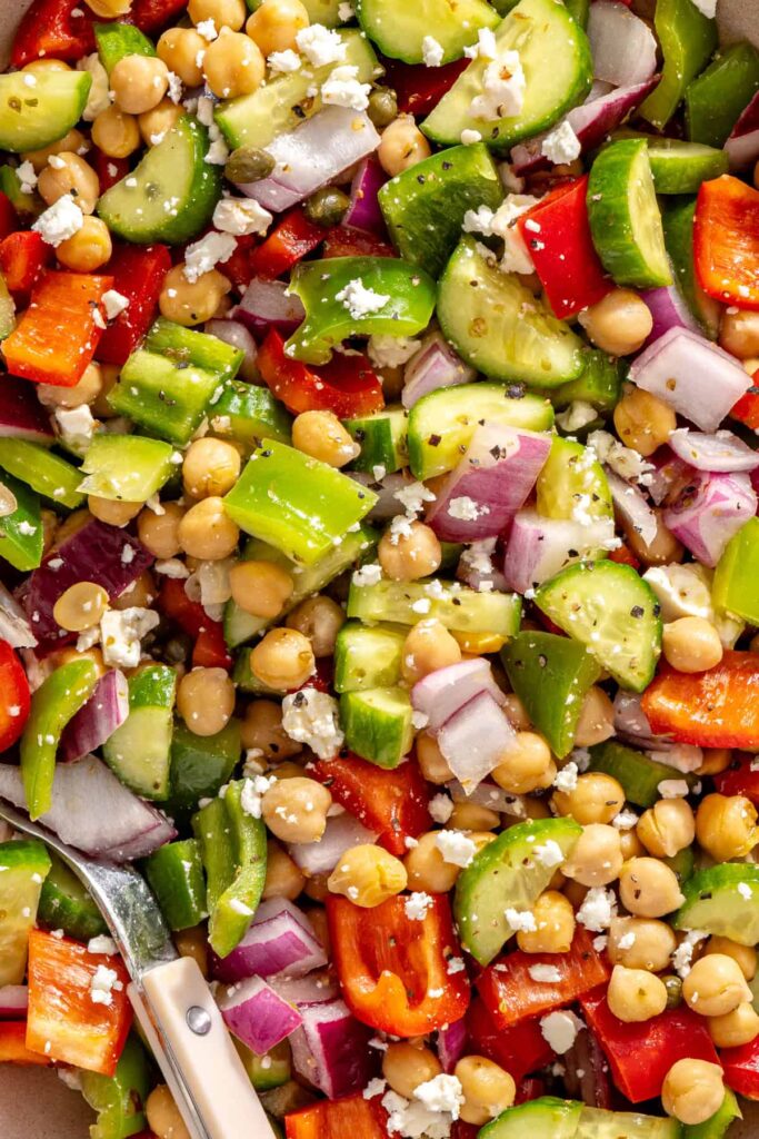 Close-up of Mediterranean chickpea salad showing chopped cucumbers, peppers, chickpeas, and feta