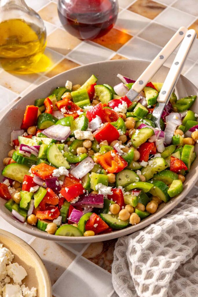 Side view of Mediterranean chickpea salad being served from a bowl