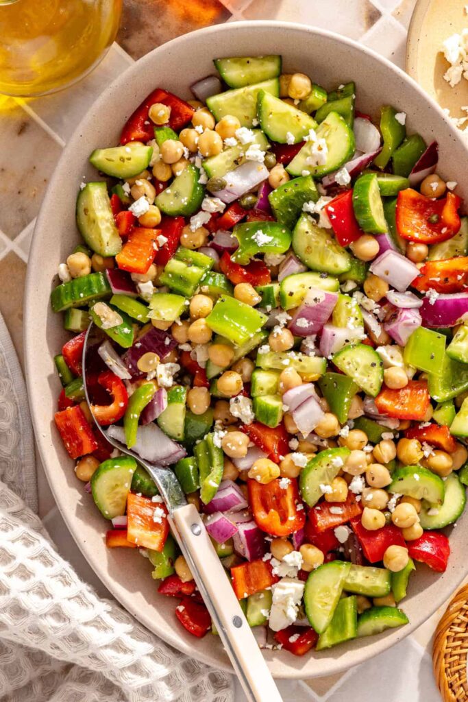 Colorful Mediterranean chickpea salad with feta served in an oval bowl