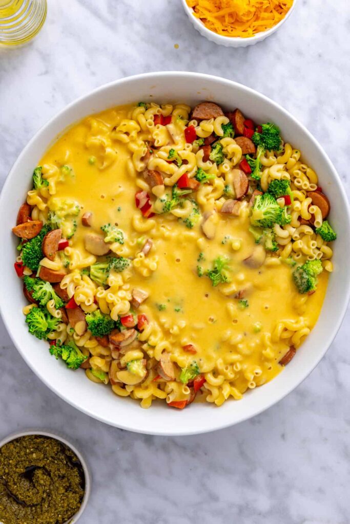 Cooked gluten-free pasta and broccoli added to the creamy cheddar sauce