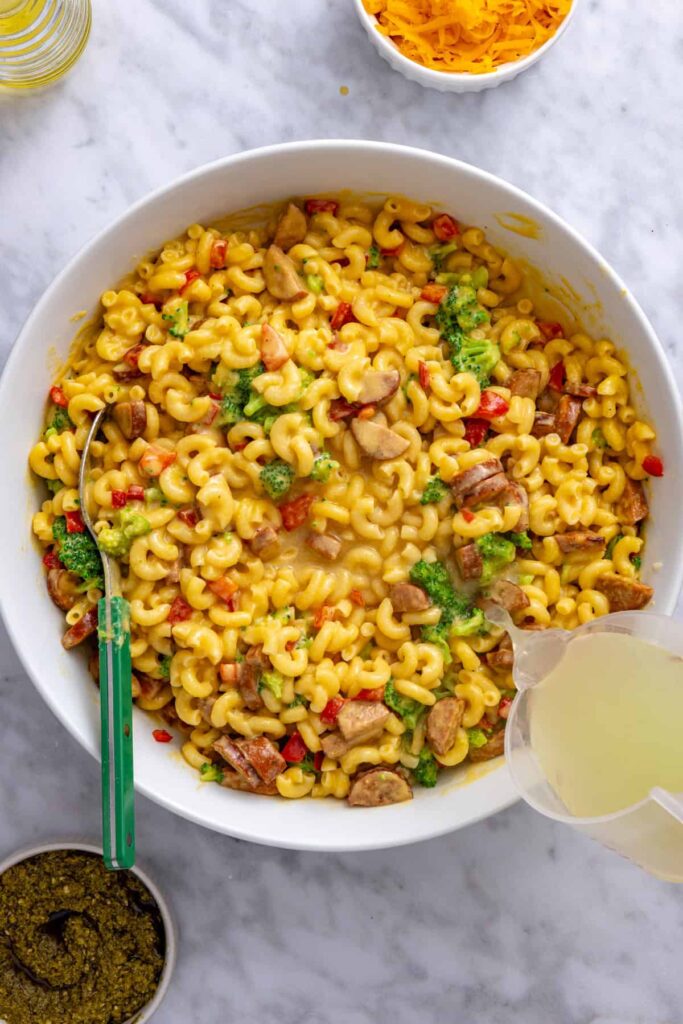 Reserved pasta water added to the broccoli cheddar pasta to loosen the cheese sauce