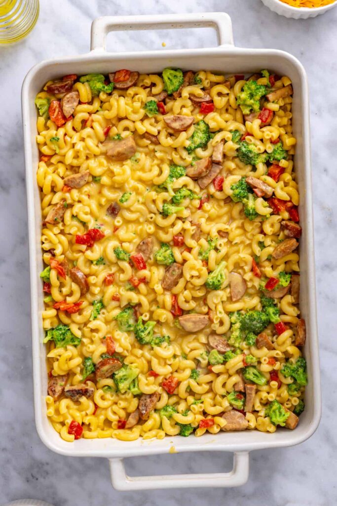 First layer of broccoli cheddar pasta spread into a greased 9x13 baking dish