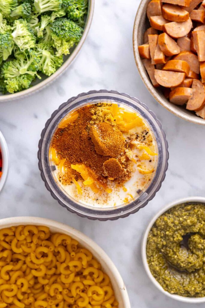 Cottage cheese, milk, shredded cheddar and seasonings added to a blender for the broccoli cheddar pasta sauce
